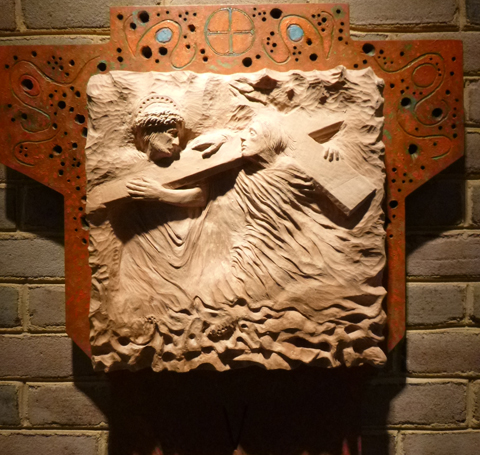 5. Simon of Cyrene helps Jesus carry the cross.